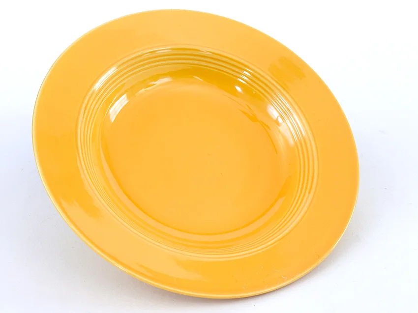 yellow vintage harlequin dinnerware deep plate made by Homer Laughlin for Woolworths